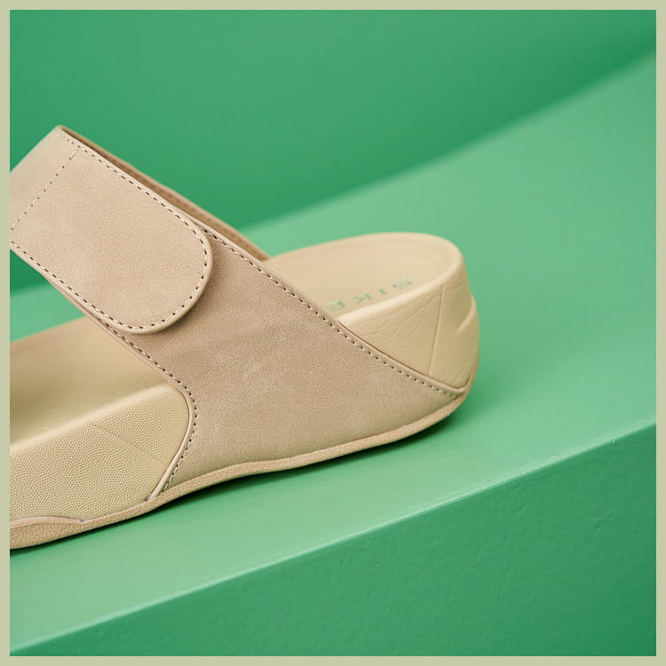Beige suede slip-on mule with a padded strap and cushioned sole from women’s platform sport sandals with velcro straps collection.