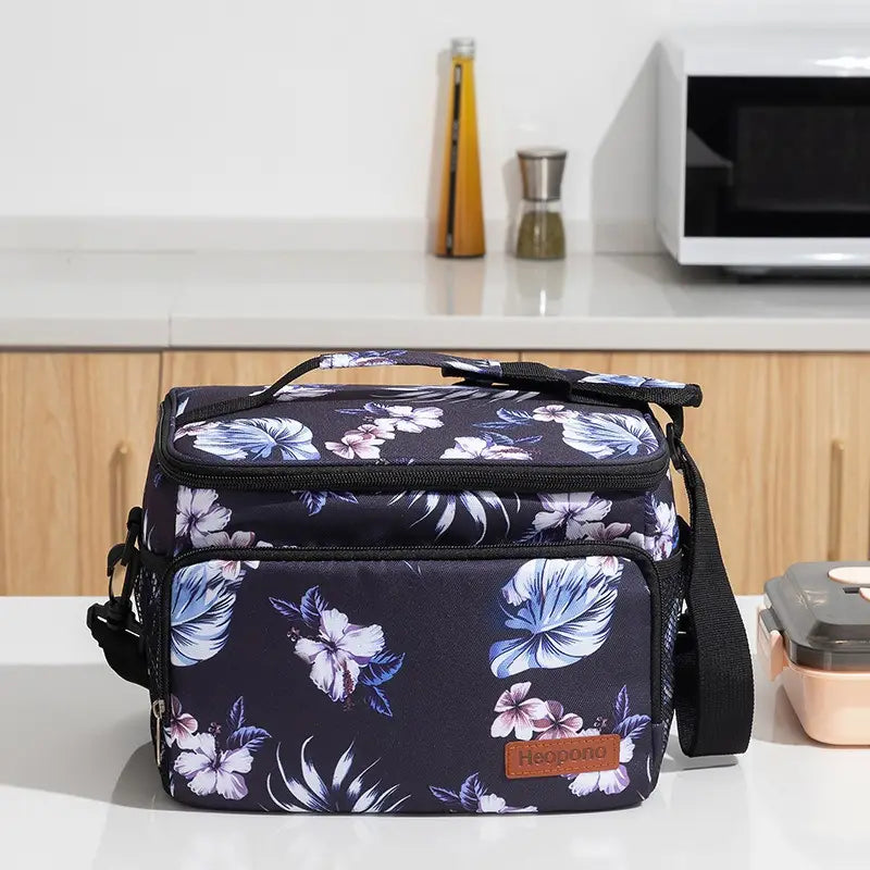 Dark navy insulated lunch bag large portable crossbody case with vibrant blue and white floral pattern featuring black zippers and straps.