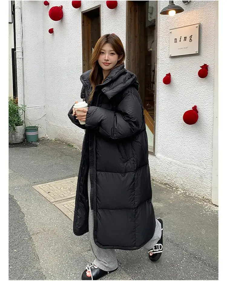 Black women’s long quilted winter puffer coat with a hood and insulated design for cold weather protection.