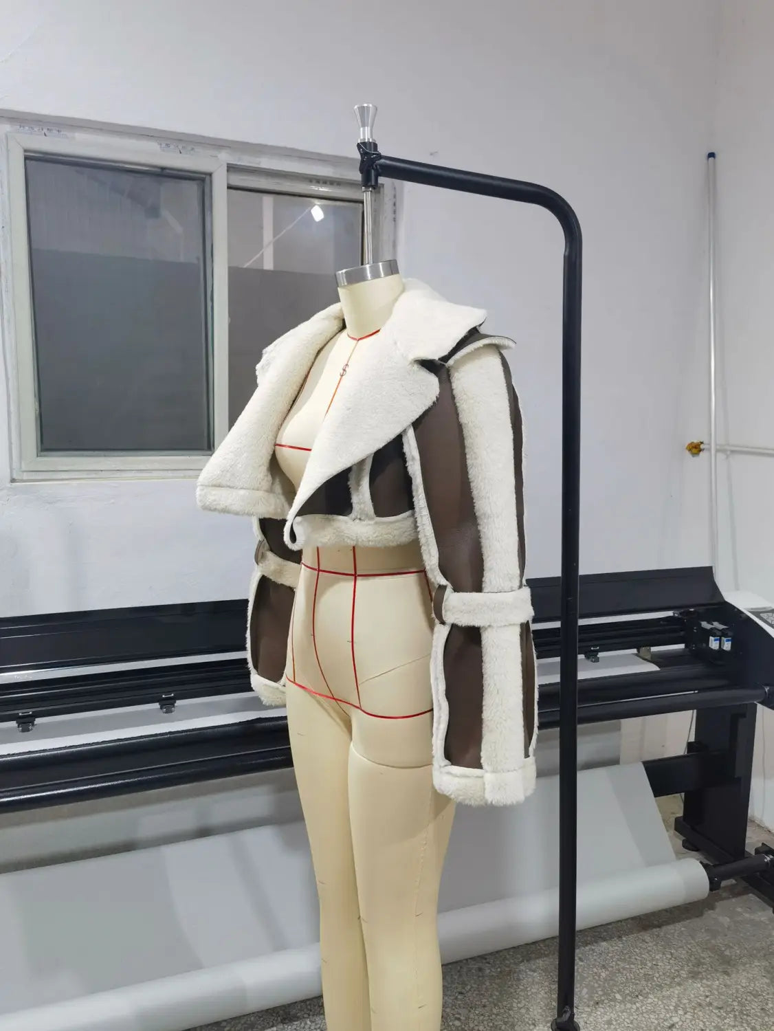 Shearling leather short jacket for women featuring a brown and white color scheme with plush soft texture and contrasting panels.