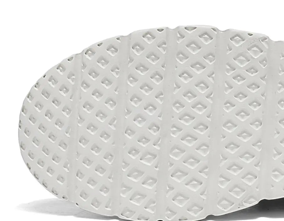 white rubber sole with textured diamond-patterned tread design on men’s mesh knit casual lightweight sneakers