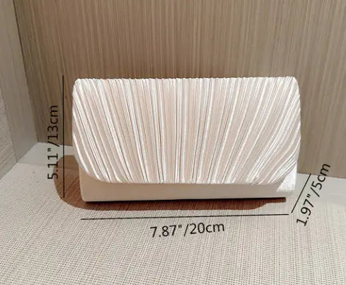 A sleek off-white pleated satin clutch with a structured rectangular shape designed as a minimalist women’s evening bag.