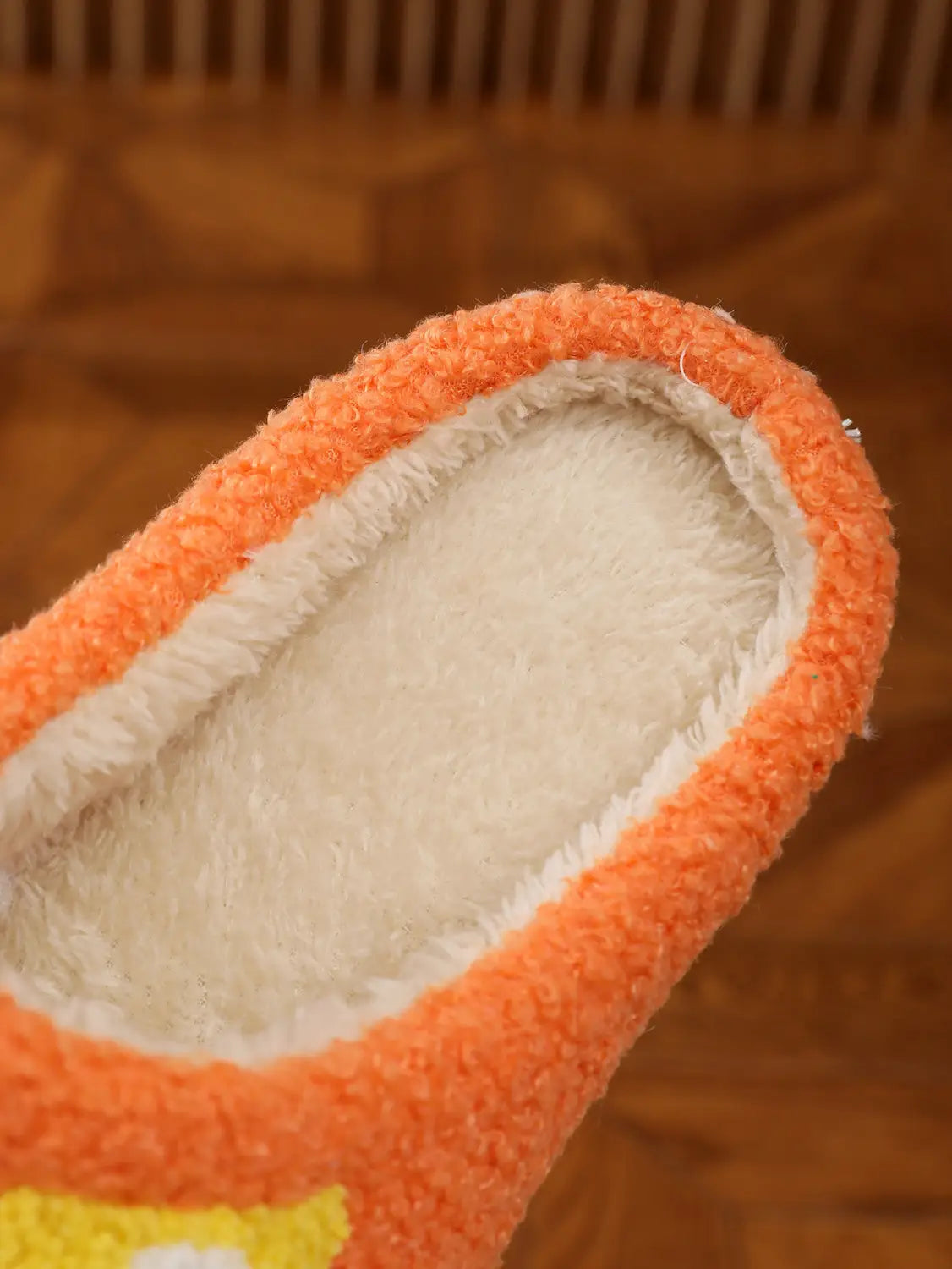 orange fuzzy slipper with plush white interior and yellow design detail from the plush floral cotton slippers with soft tpr sole collection