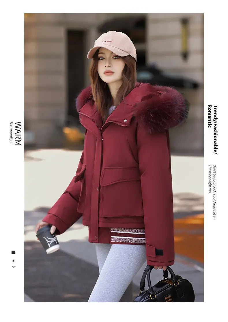 A maroon faux fur collar puffer jacket featuring a plush dark red fur-lined hood and front pockets.