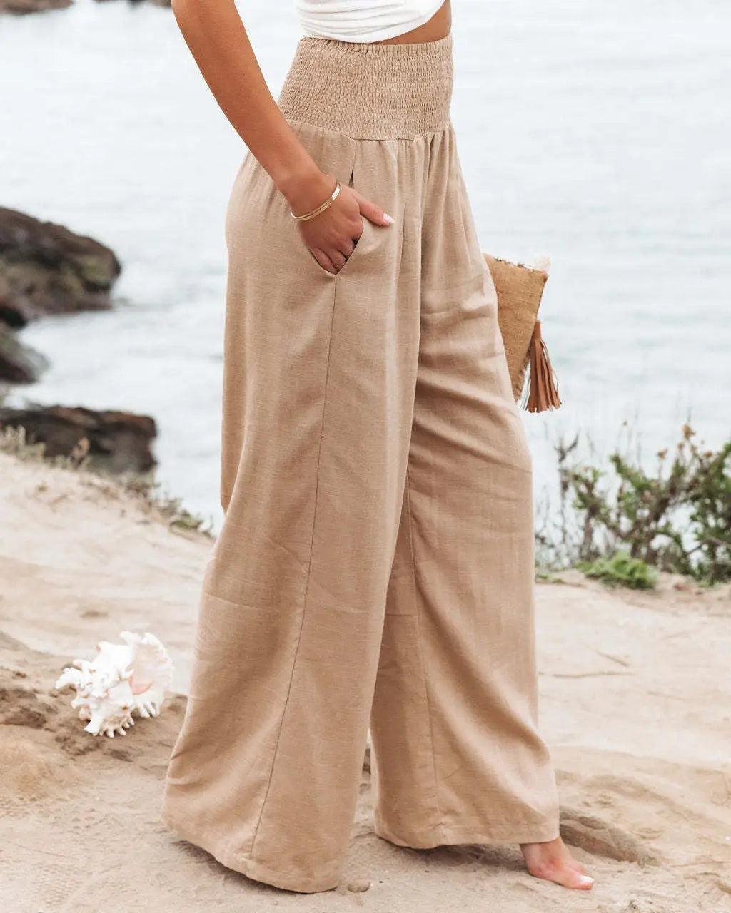 beige wide-leg linen pants with a smocked waistband designed for women in a solid color high waist style