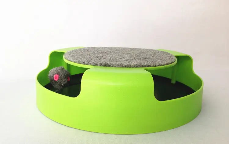 Tobogán/rueda giratoria interactiva para gato de color verde brillante, con una parte superior de fieltro gris y un pequeño ratón de peluche en el interior, diseñado para un juego estimulante.