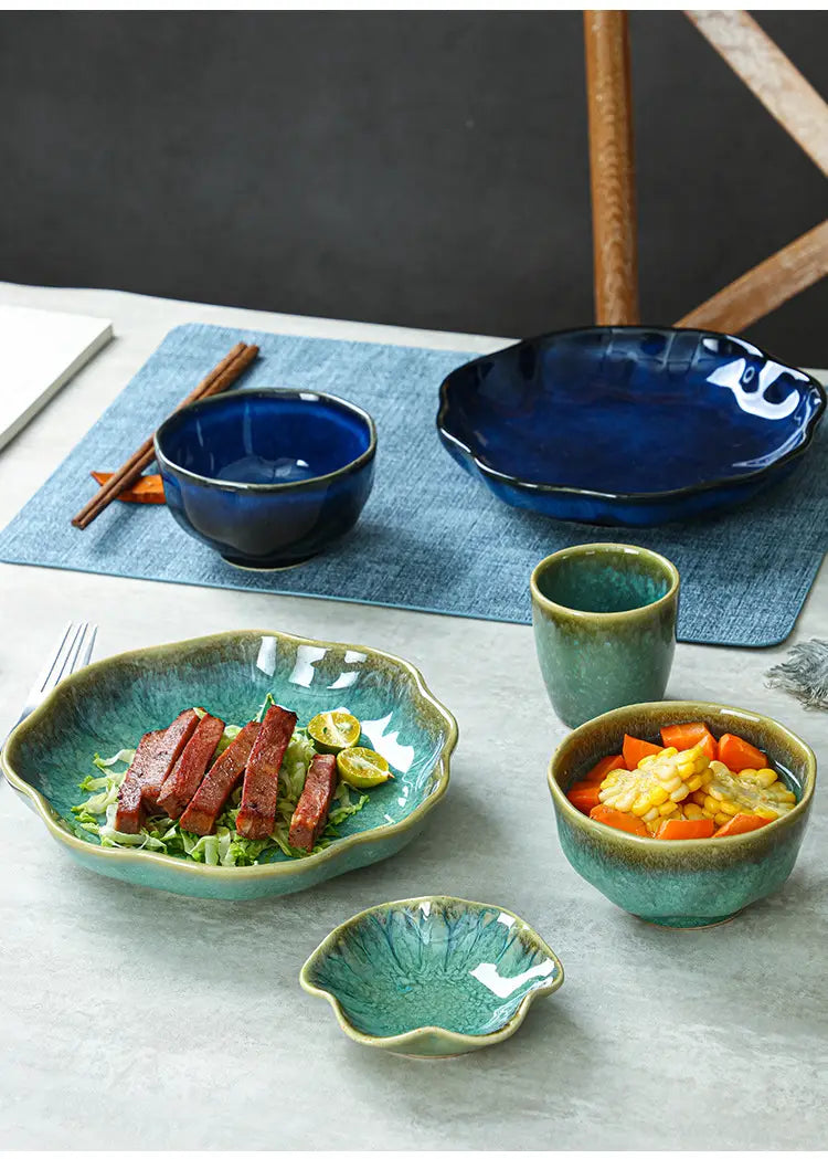 Ceramic tableware set scalloped fambe diamond dishes with glazed leaf-shaped bowls and plates in deep blue and teal hues.
