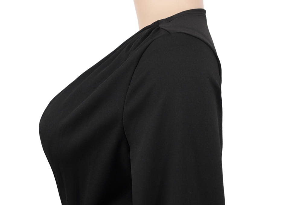 Black form-fitting top with a high neckline and long sleeves shown as part of a velvet v-neck evening dress ensemble.