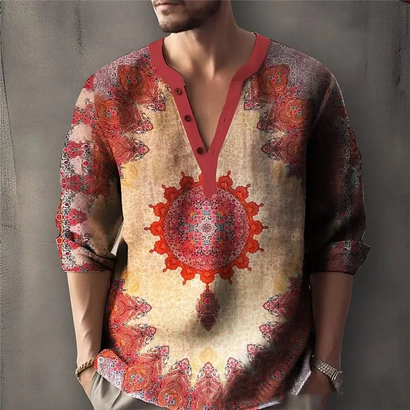 Un hombre que viste una camisa de lino para hombre con cuello en V y estampado de mandala vibrante, con un intrincado patrón rojo y beige sobre un tejido ligero.