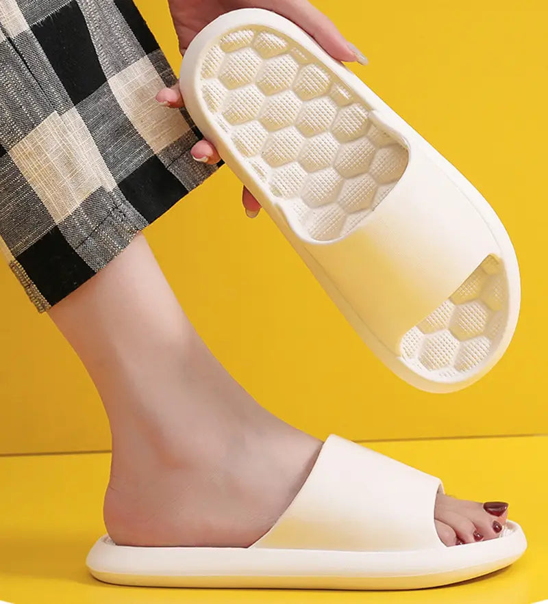 cream-colored massage slippers rubber slides with honeycomb-textured sole and open-toe design
