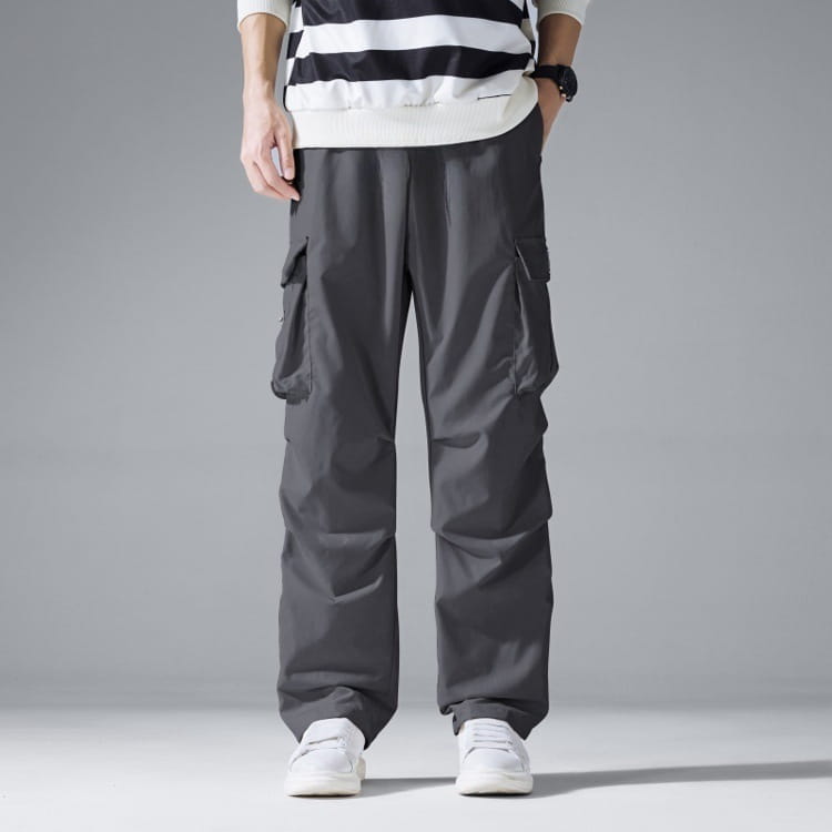 Dark gray mens multi pocket cargo workwear pants featuring multiple side pockets and a relaxed straight leg cut.