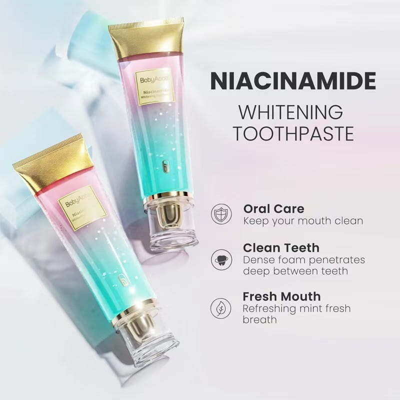 two gradient-colored niacinamide whitening toothpaste tubes for men and women with gold caps and clear bases featuring a pink-to-teal ombre design