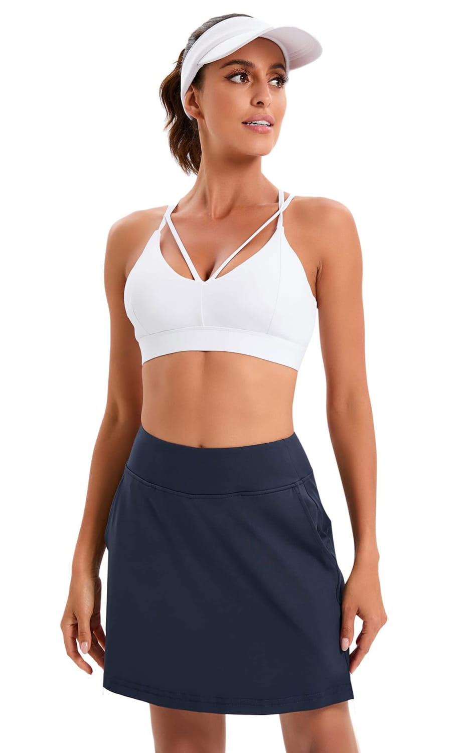 white and navy paisley high-waisted athletic tennis skirt set featuring a white sports bra with crisscross straps and a navy skirt designed for active use