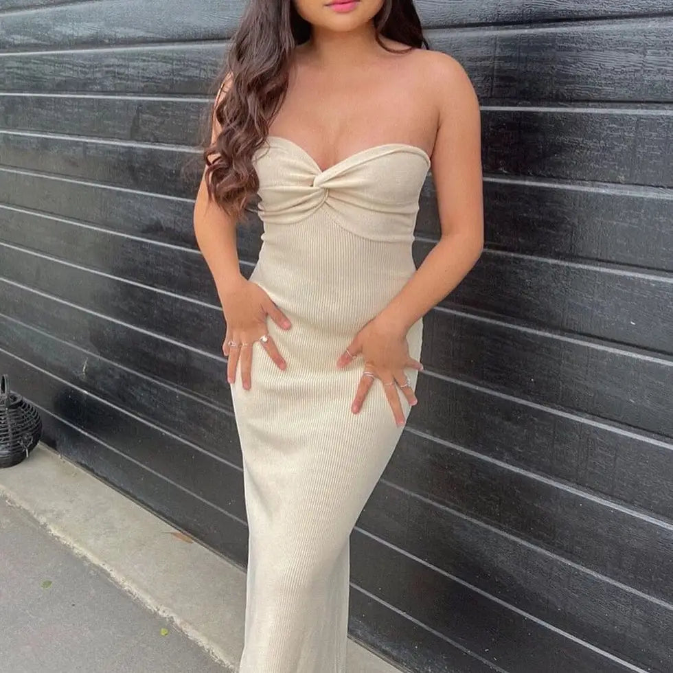off shoulder knotted ribbed knit midi dress featuring a strapless cream-colored ribbed design with a twisted bodice.
