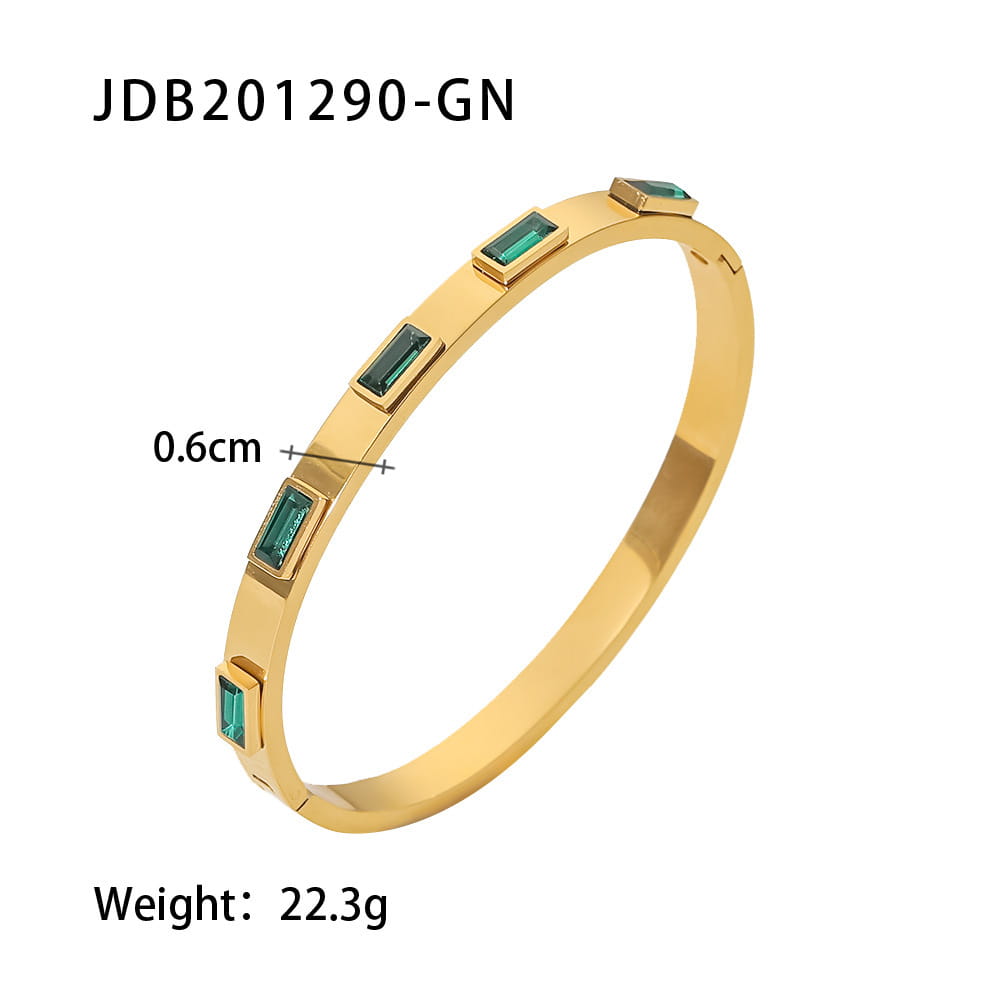 Gold plated stainless steel bangle bracelet featuring five rectangular emerald green zirconia gemstones in a sleek modern design.