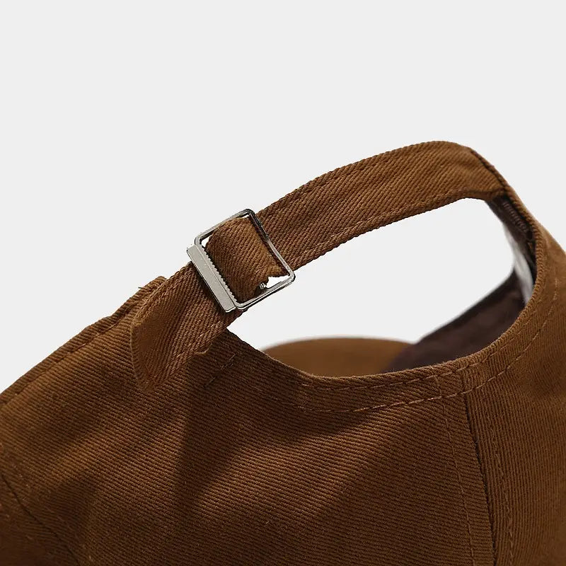 brown corduroy strap with silver-toned metal buckle on the back side of frog mushroom embroidered baseball cap