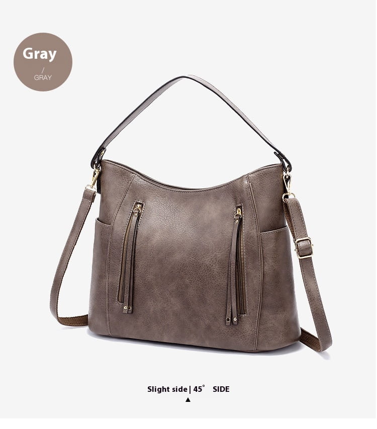 gray faux leather hobo bag with dual zippers and tassel details featuring front zipper pockets for secure storage