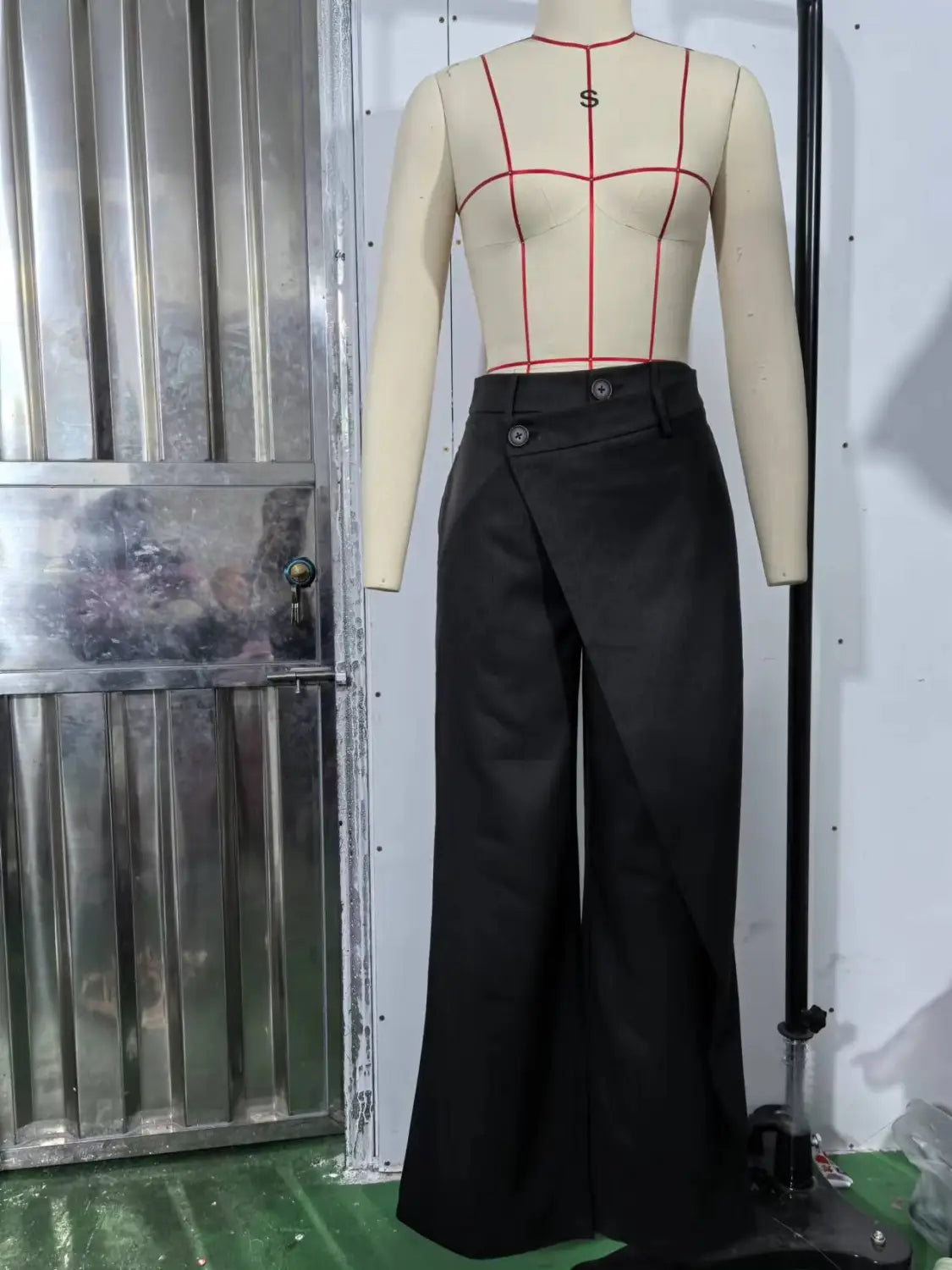Schwarze hochtaillierte asymmetrische Weitbein-Hosen mit Vorderklappe und Knopfleisten – perfekt für formelle oder Business-Anlässe.