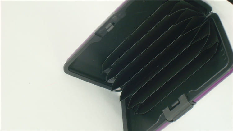 Black plastic rfid blocking aluminum alloy ribbed card holder case with purple trim and multiple card slots.