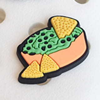 A vibrant molded rubber food themed shoe charm shaped like a green bowl of guacamole with yellow tortilla chips for sandals and clogs.