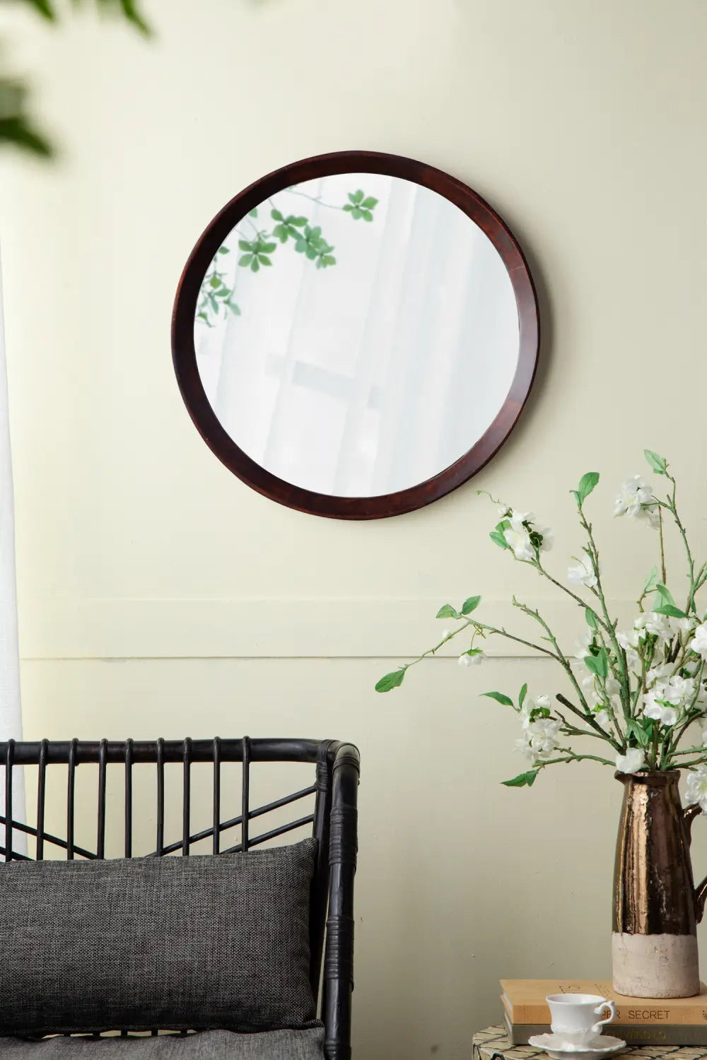 Mango wood round wall mirror with a 20 inch dark bronze wooden frame and a dark brown finish.