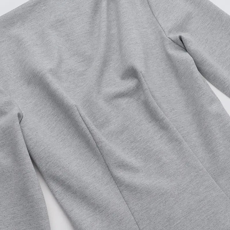 A soft heather gray slim fit long sleeve a line flared dress made of smooth slightly textured fabric.