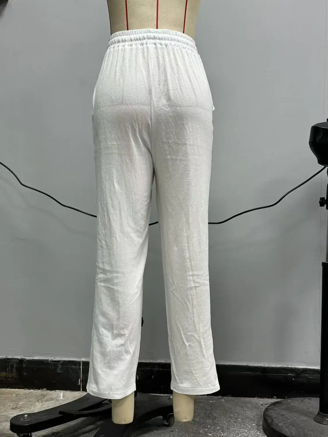 White textured cotton cropped patchwork button casual pants for women featuring an elastic waistband.