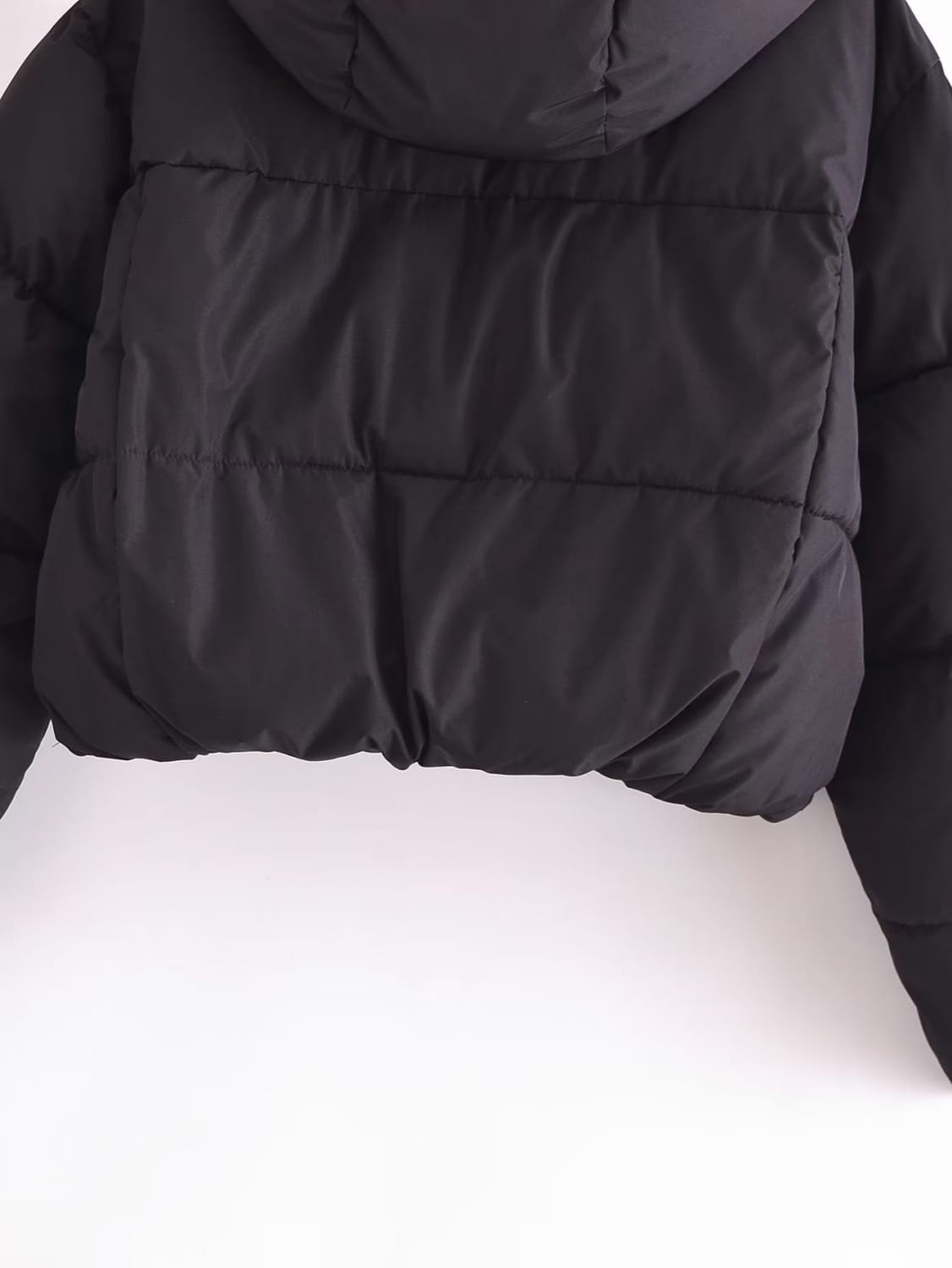 Black quilted hooded puffer coat in black with a quilted design and hood for cold weather.