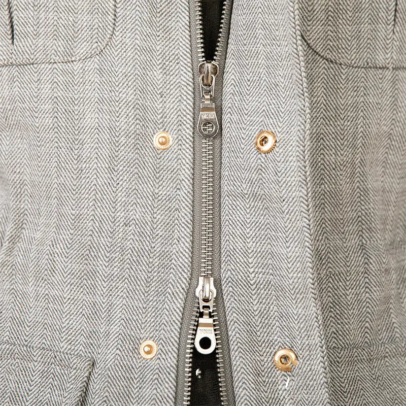 Cotton linen M65 safari jacket in gray with a herringbone pattern featuring gold-toned buttons and a silver zipper.
