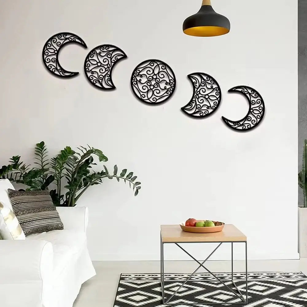 Black metal wall art featuring a series of intricately designed moon phases in a five piece set for decorative use.