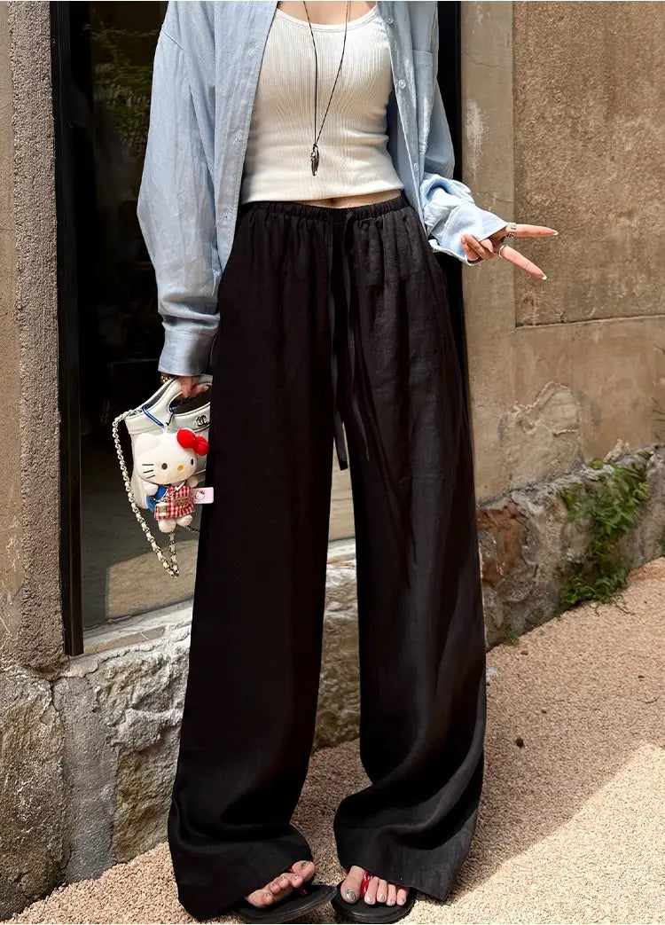 Pantalon noir à jambes larges avec taille élastique et cordon, sur l’image du produit du pantalon ample en lin blanc à jambes larges