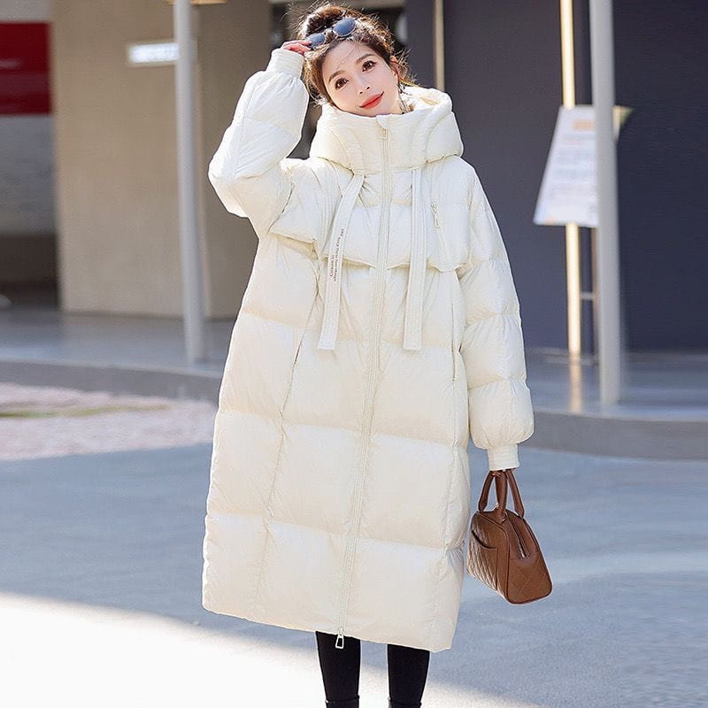 Cream-colored women long hooded puffer coat featuring a quilted down design with a hood and drawstring ties.