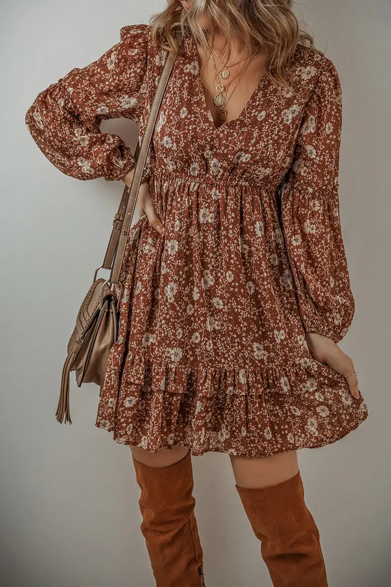 Bohemian rust floral tiered mini dress featuring long flutter puff sleeves and a tiered hem in a lightweight fabric.