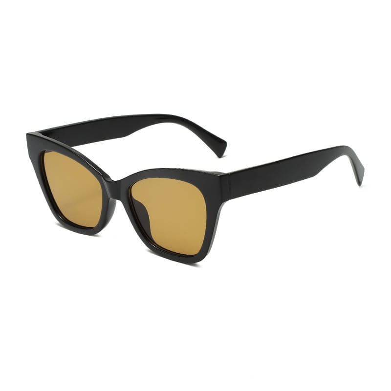 Gafas de sol con forma de ojo de gato color negro con lentes tintadas ámbar que ofrecen protección UV en un diseño de estilo retro.
