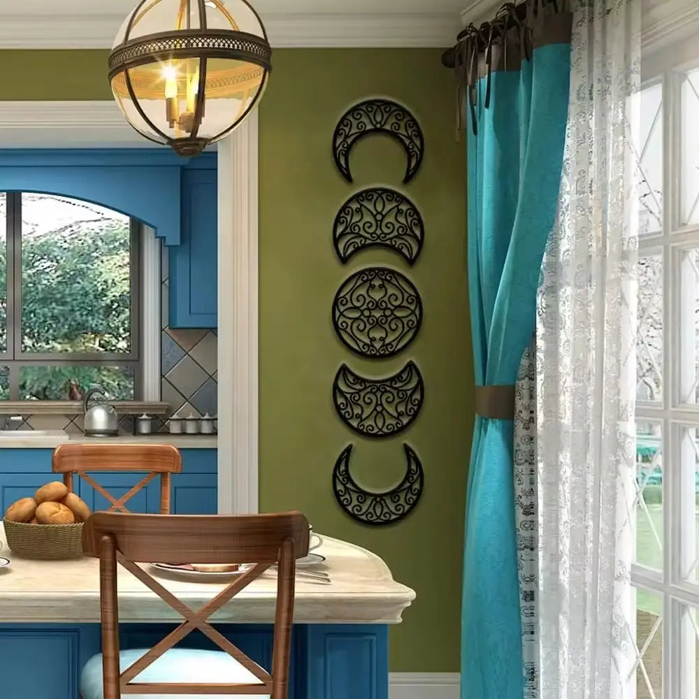 Black metal wall art featuring the five phases of the moon in an ornate scrollwork design for elegant home decor.