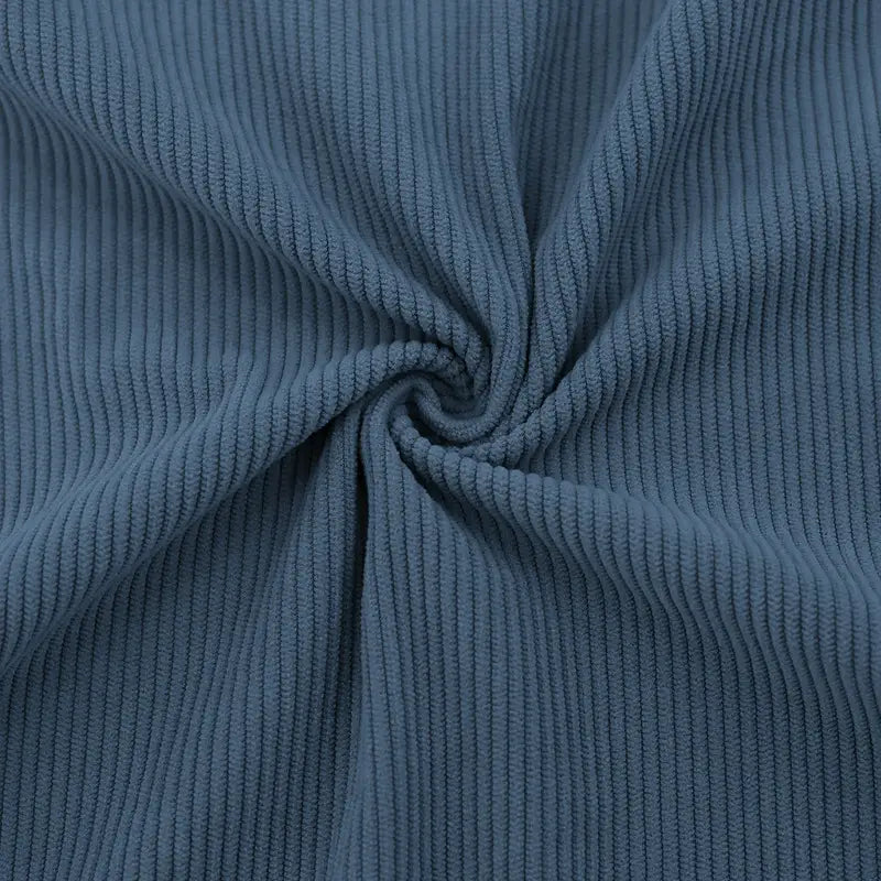 A slim fit corduroy patchwork pullover with contrast accents made of soft dusty blue ribbed corduroy fabric.