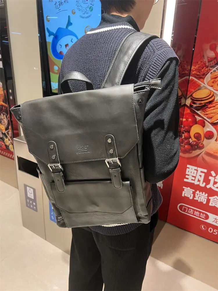 Dark gray leather vintage leather college backpack with silver-toned metal buckles and a large capacity minimalist design ideal for travel.