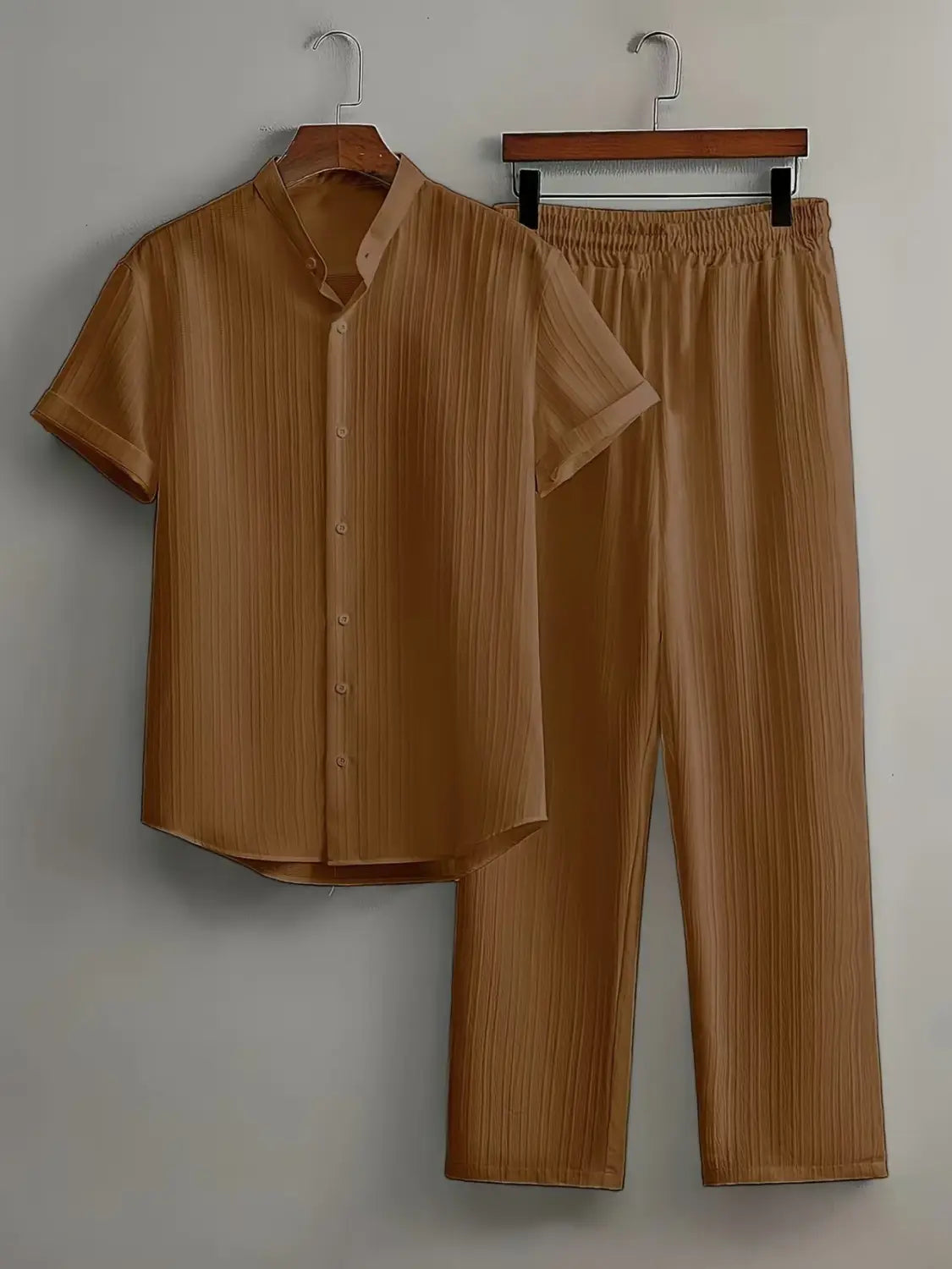 Mens pleated tan short sleeve button-up shirt and matching pants set made from lightweight fabric for casual wear