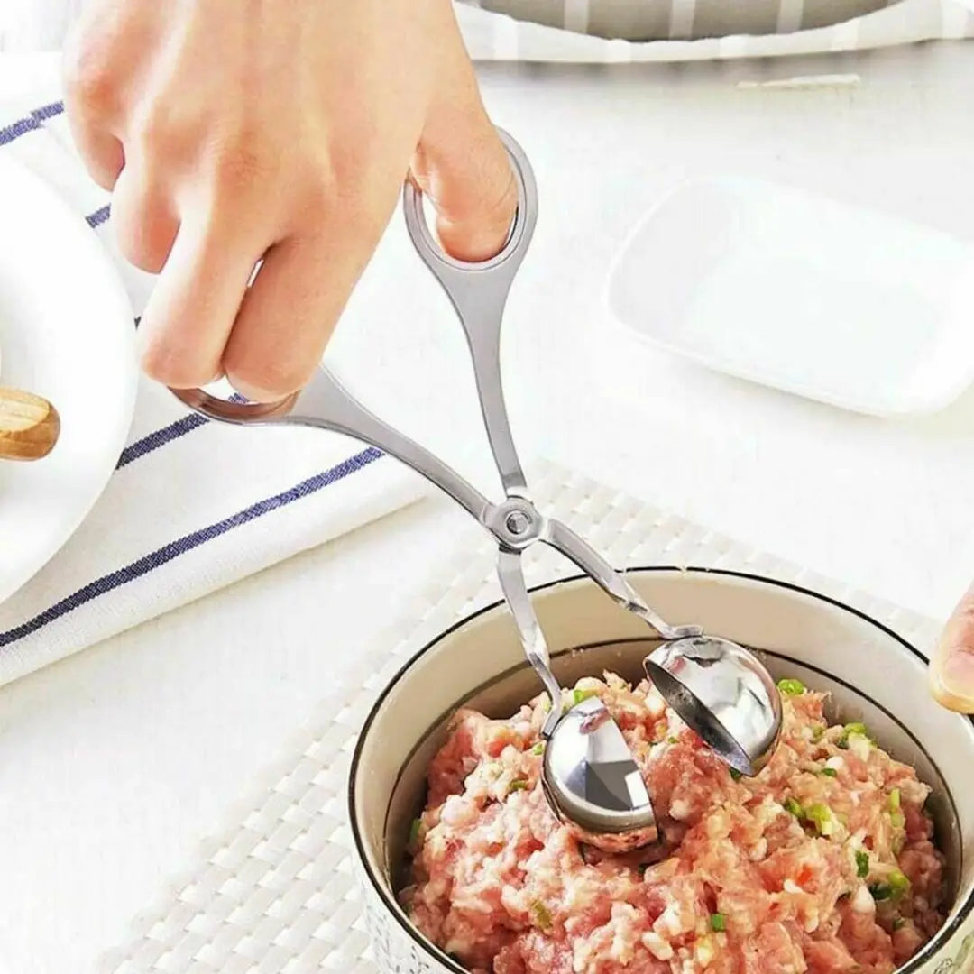 Silver stainless steel meatball maker tongs featuring two rounded polished metal scoops with ergonomic handles for kitchen use.