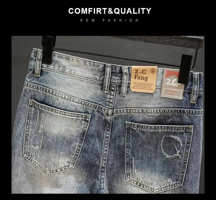distressed maple leaf denim shorts in blue with faded wash and frayed pocket edges featuring the z.c fang brand label.