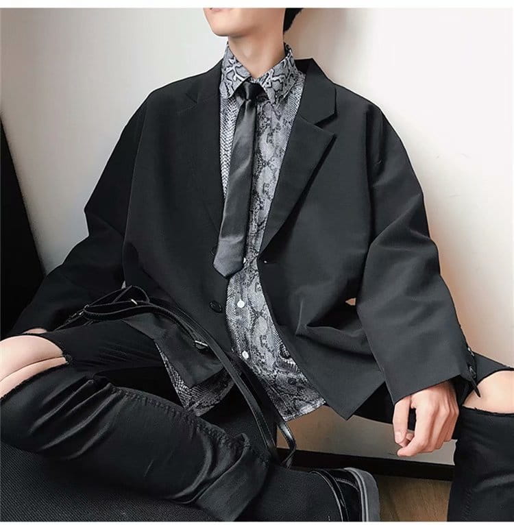 Black oversized mens loose casual thin suit jacket with a relaxed fit and subtle texture.