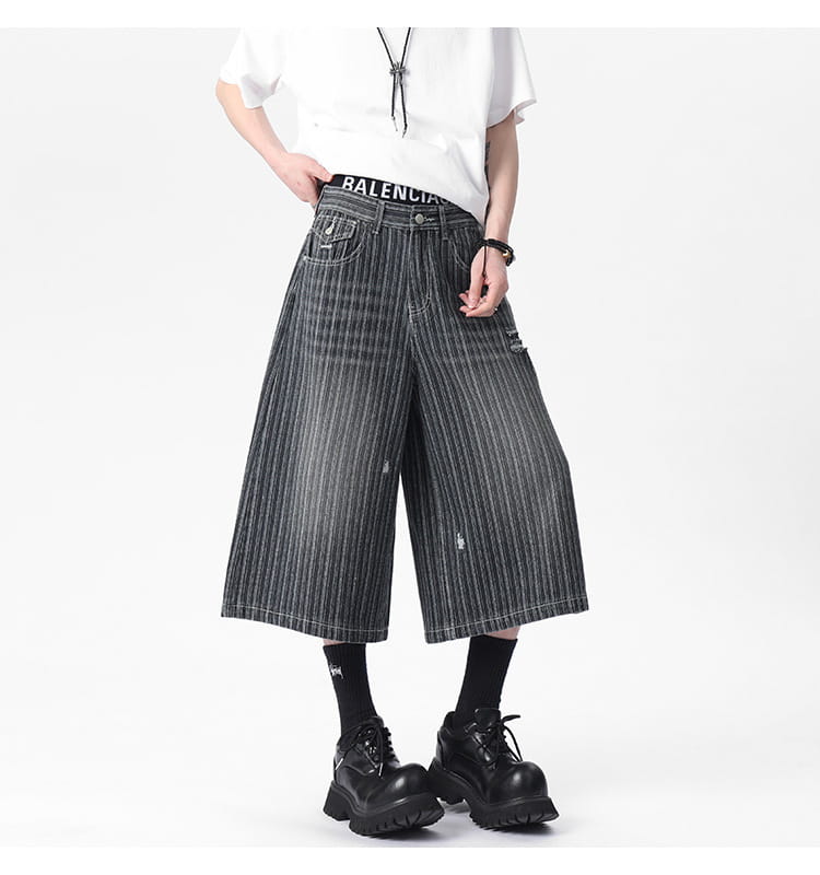 black and white vertically striped wide-leg denim capri shorts with a distressed vintage look