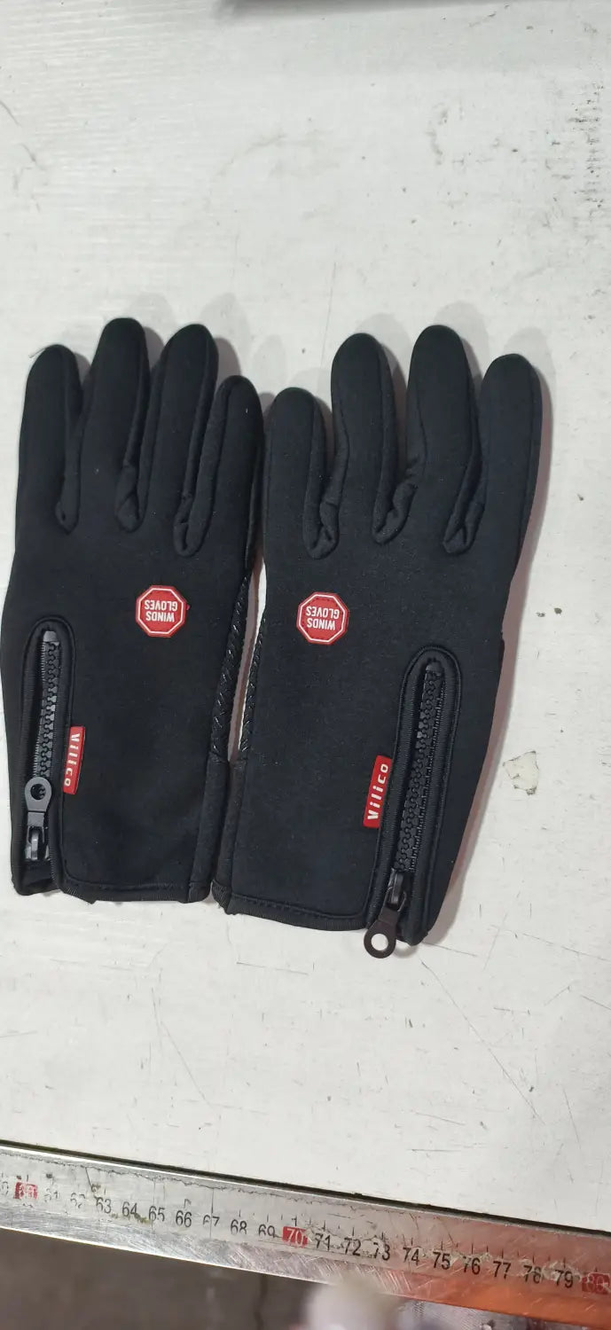 black waterproof windproof touchscreen winter gloves for men and women showing the back side with red zipper pulls and a small circular logo on each hand