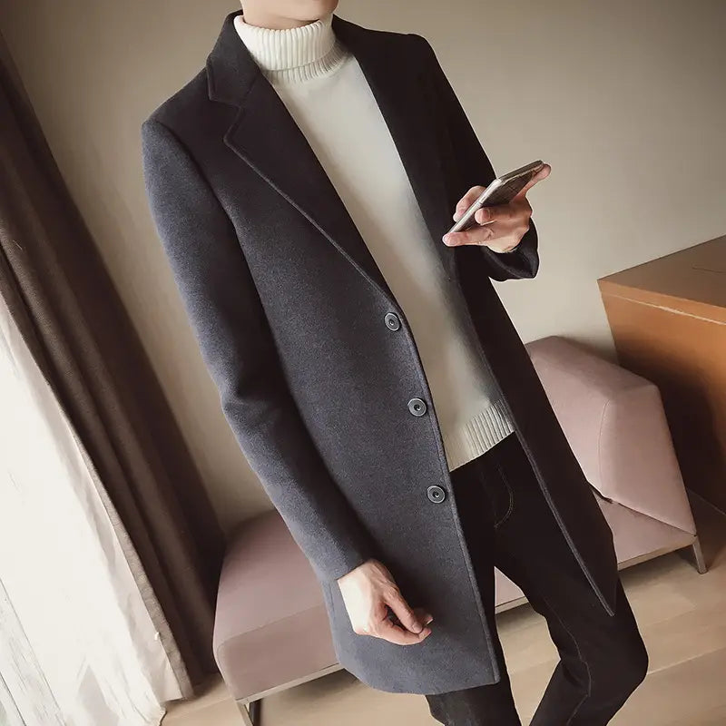 Dark gray woolen mens slim trench coat in Korean style featuring a classic double-breasted design with matching buttons.