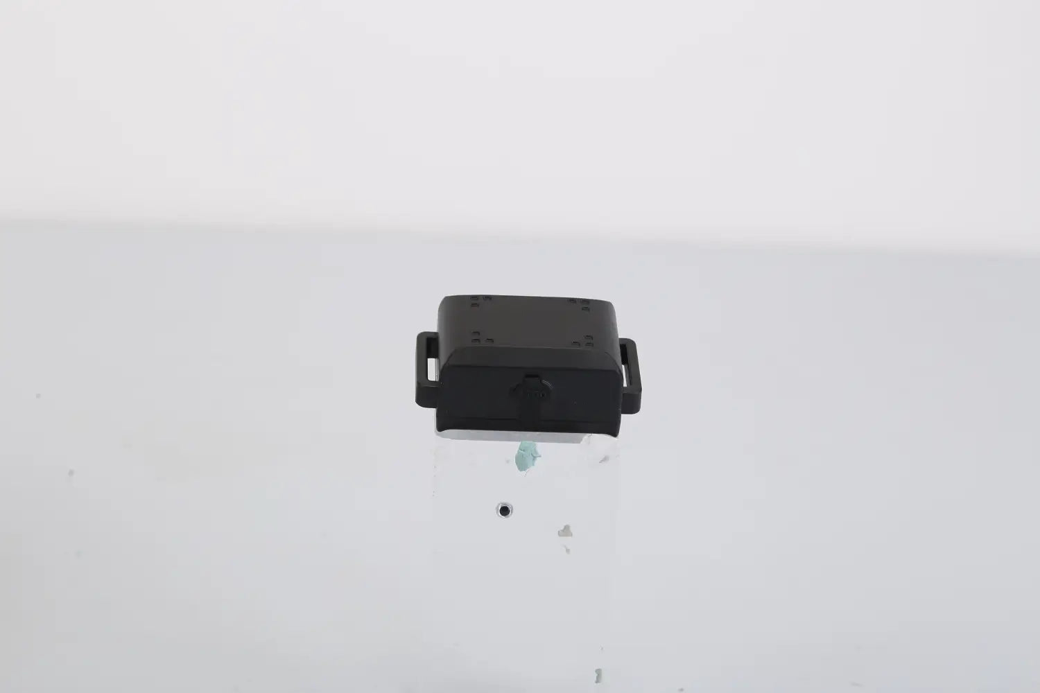 black plastic car door handle latch with integrated keyhole and side-mounted clips shown on the back side of a dog training collar 3280ft waterproof shock system product