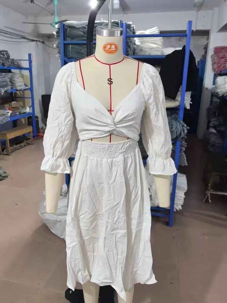 white long-sleeved peasant-style dress with fitted bodice and smocked waistband from the v-neck lantern sleeve reversible midi dress collection
