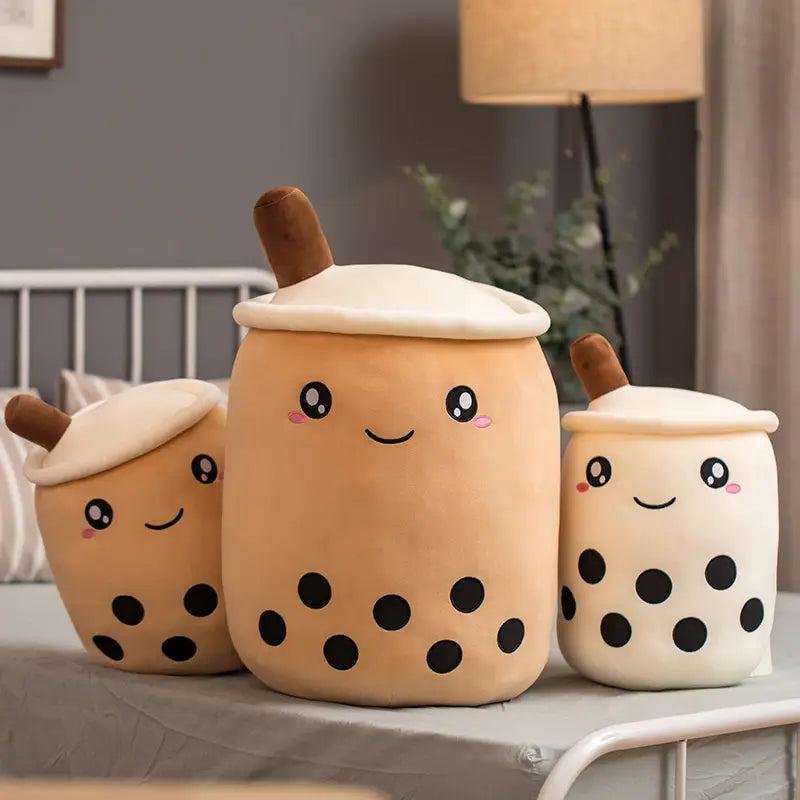 cute beige plush boba milk tea drink pillows with black tapioca pearls and brown straws designed as soft stuffed hugging pillows