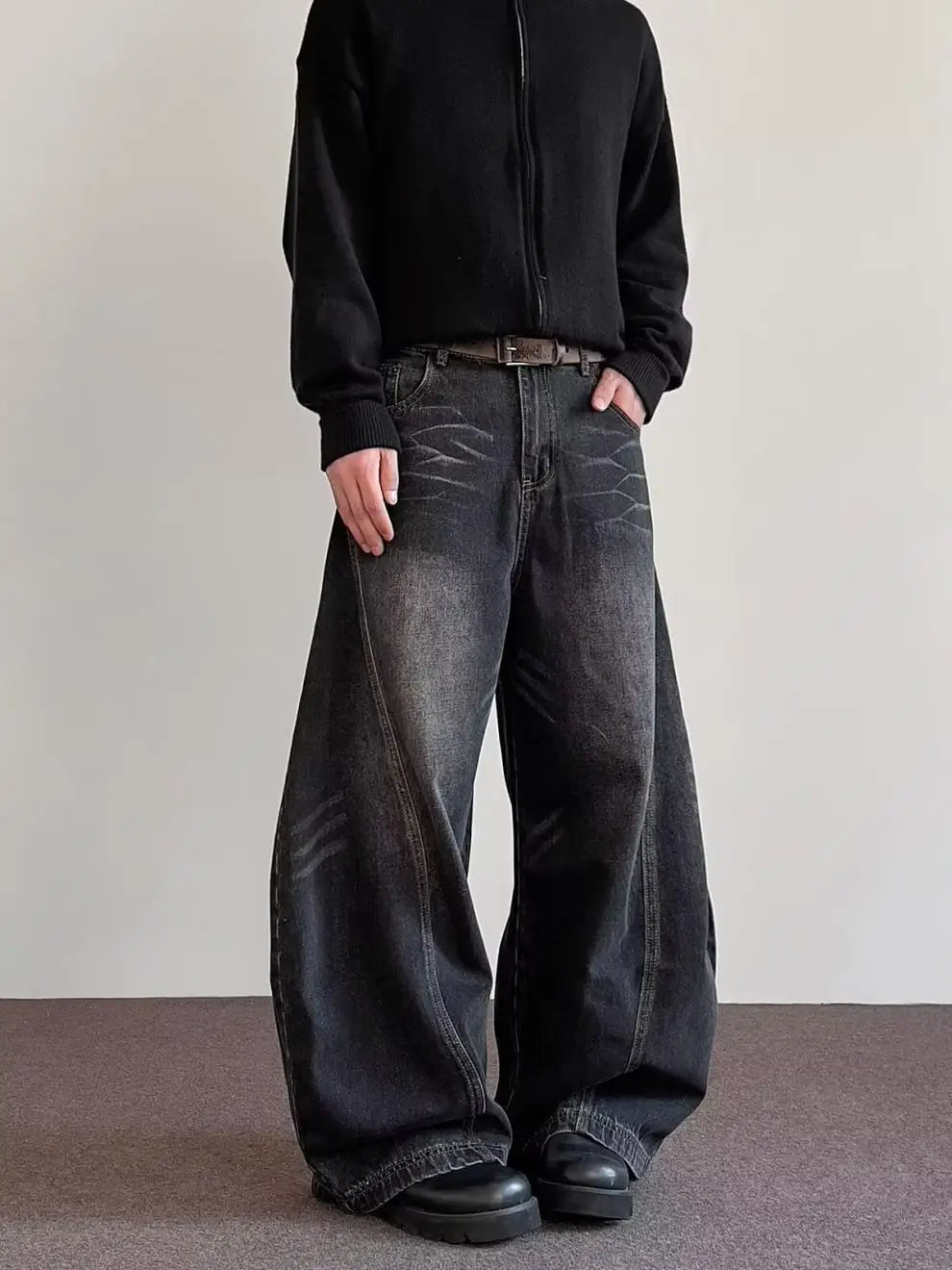 Men’s premium relaxed wide leg denim jeans in black with a faded distressed texture and visible stitching details.