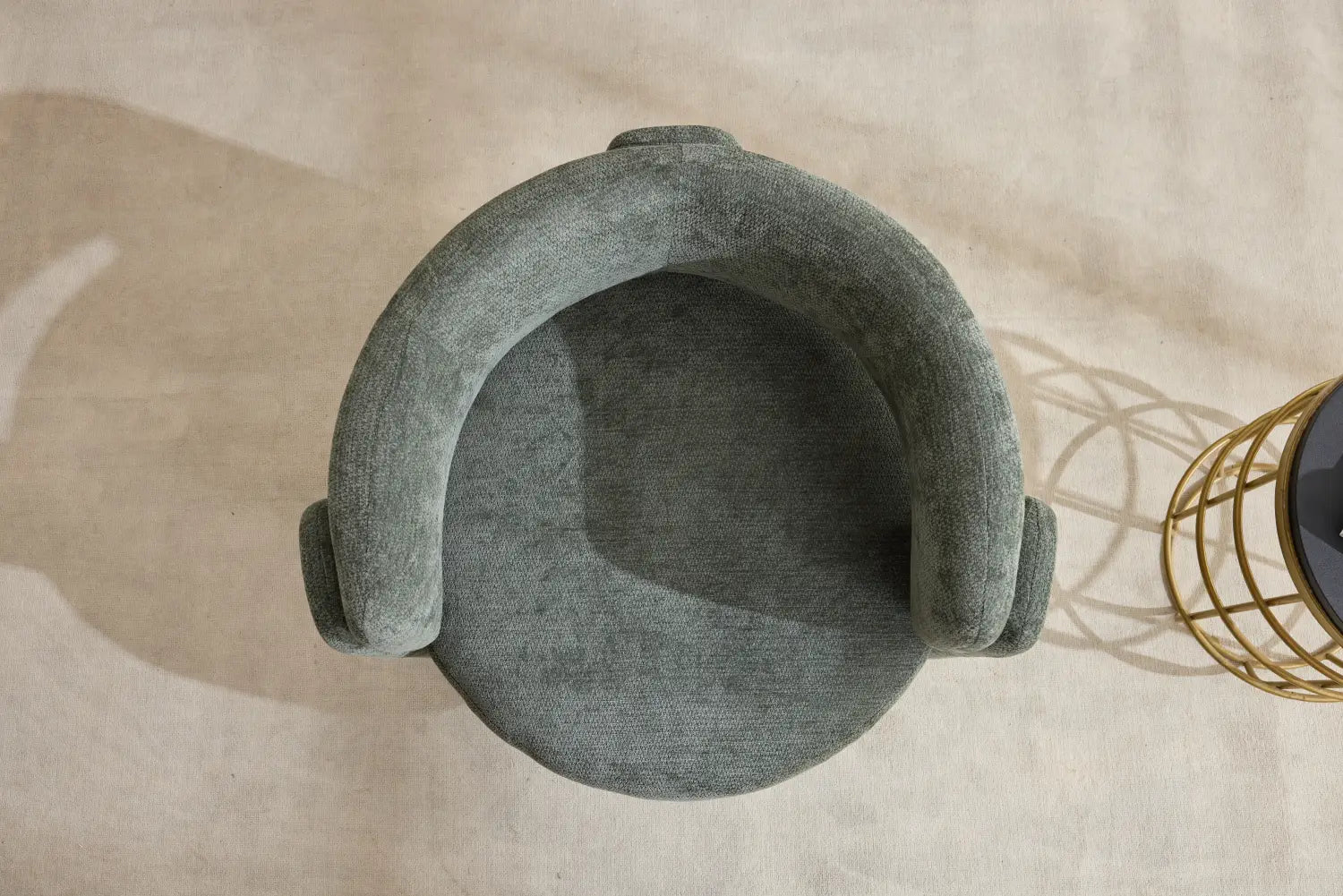 Ein gemütlicher, gerundeter grauer Armlehnstuhl mit gepolstertem Bezug aus weichem Stoff und geschwungenen Armlehnen im modernen Bouclé-Akzentstuhl-Stil.