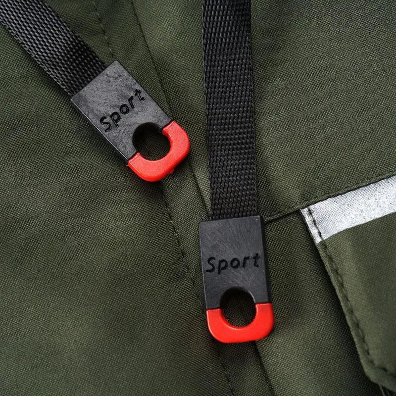 mens outdoor fleece hooded jacket with casual shell coat shown with black and red sport branded strap adjusters on a green fabric backpack on the back side of the product.